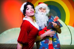 Carlotta (Dan Cimo) cavorts with a tropical Santa